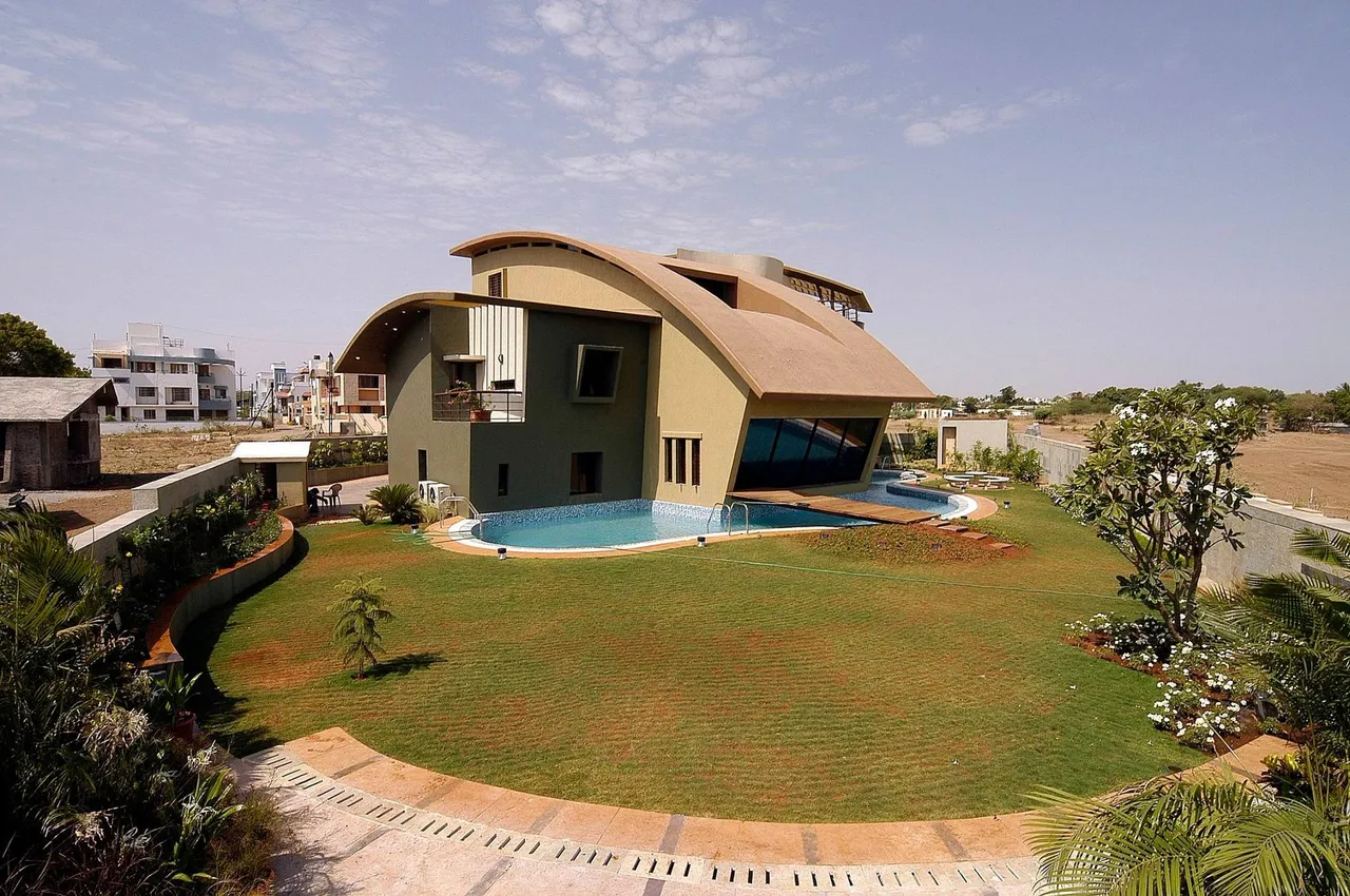 Villa with a sweeping curved roof and pool